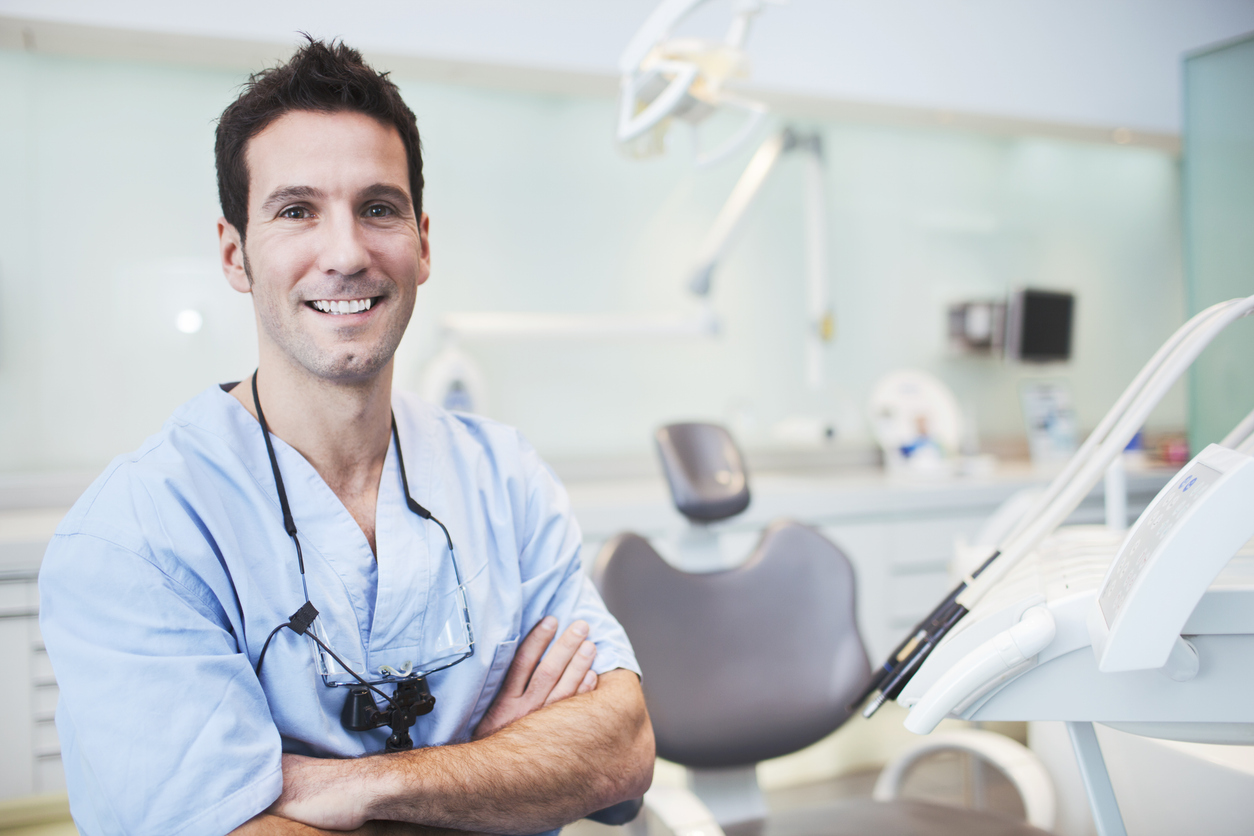 Dentist smiling in exam room