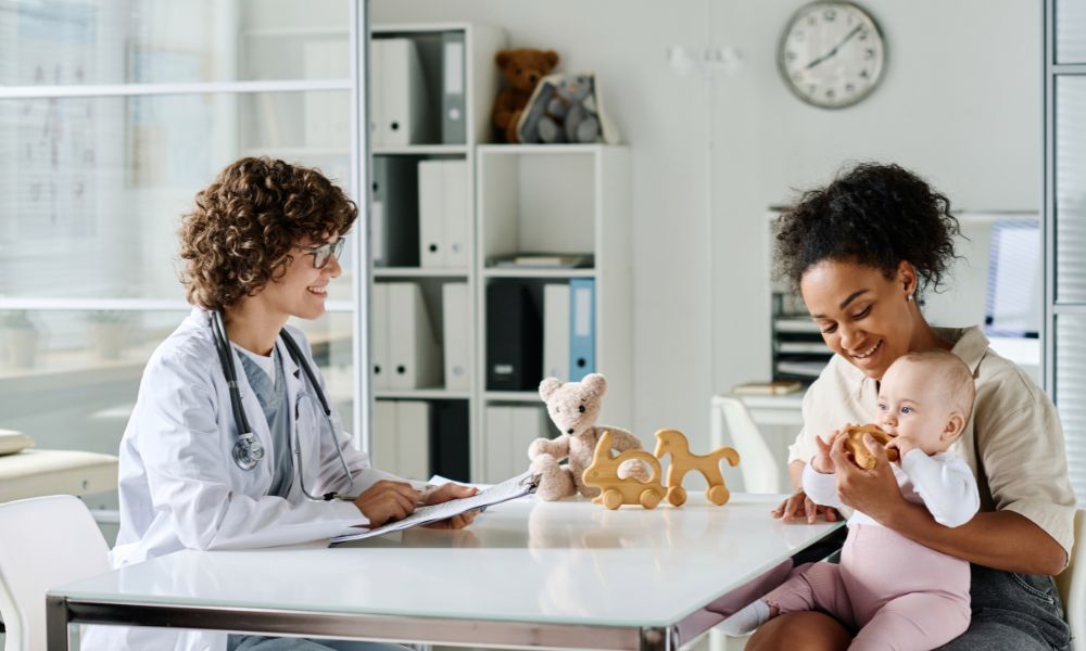 Woman visiting doctor with her child