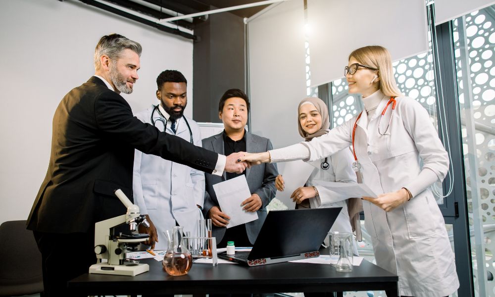 a business broker shaking hands with medical practice staff