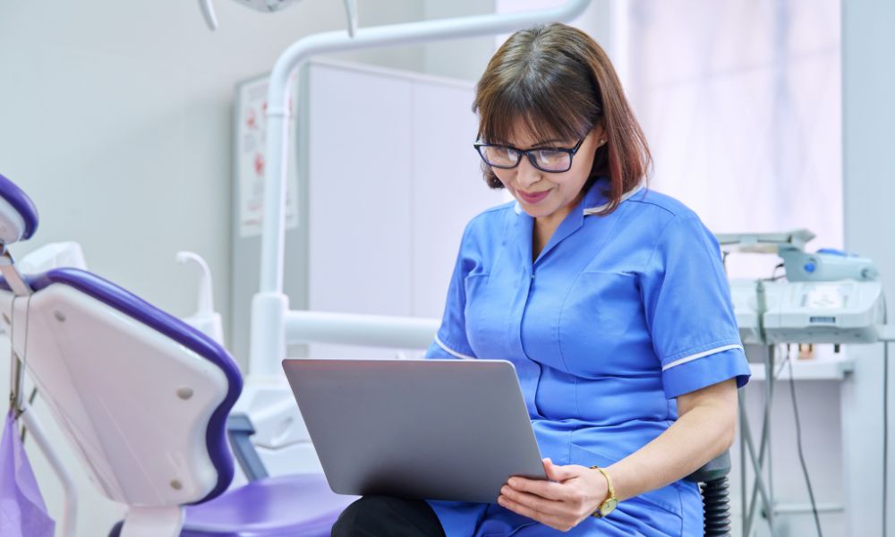 a dentist browsing on her laptop