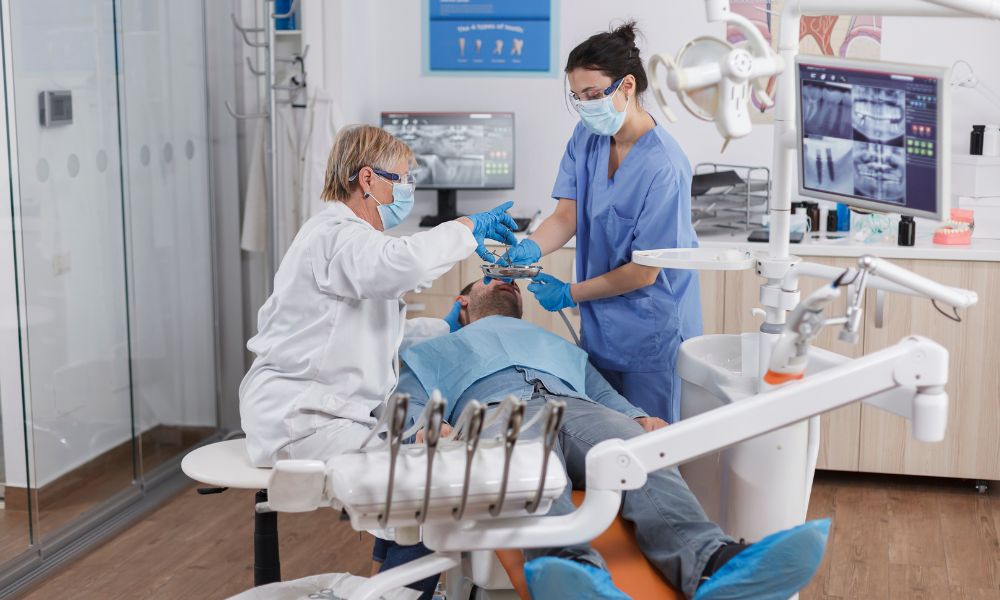 a doctor, a nurse, and a patient at a dental practice