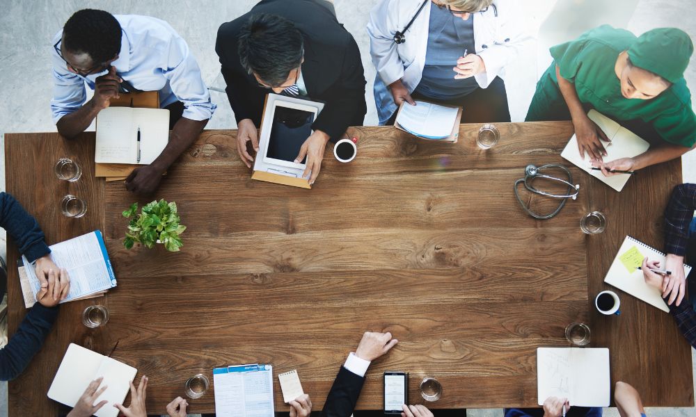 an aerial view of medical professionals and business brokers having a meeting