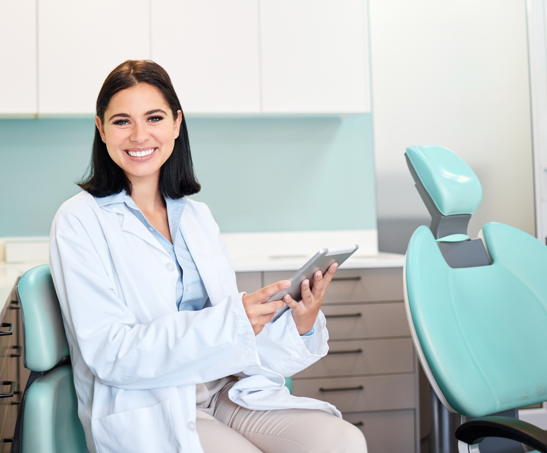 Smile, tablet and portrait of woman dentist with confidence in her office doing research at clinic. Happy, medical and young female orthodontist or dental doctor with digital technology in hospital.