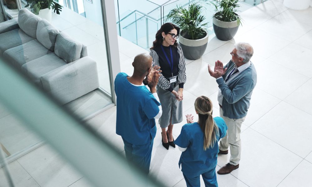 medical practice staff and a business broker celebrating a sale
